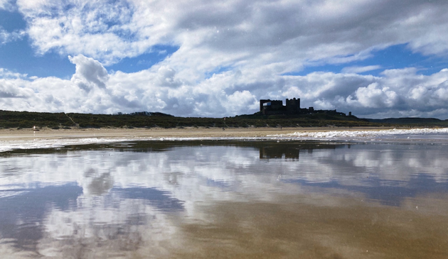 Bamburgh Castle reflected in the aftermath of the retreating tide