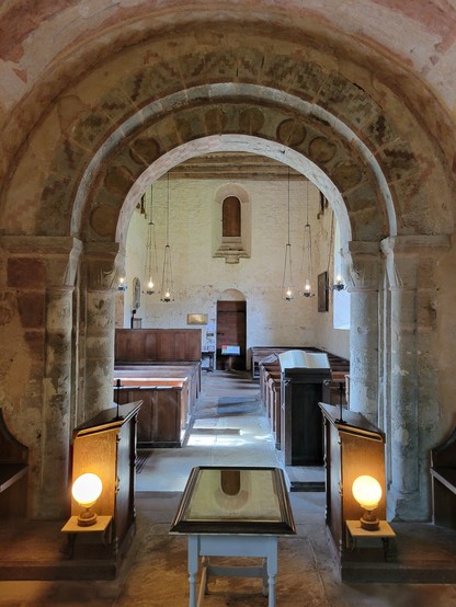 St Mary's Church, Kempley. A view from the chancel towards the nave, showing the Norman chancel arch decorated with patterns.
