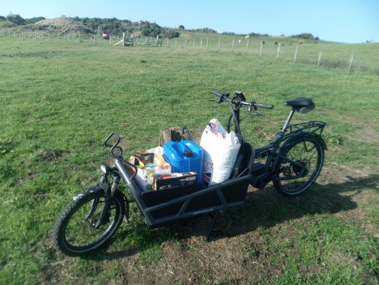 The same bike with the same load, at the top of my croft, with the roundhouse in the background. The sunlight is still bright, but slightly less so.